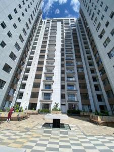 a large white building with two tall buildings at Meteor gardens in Nairobi