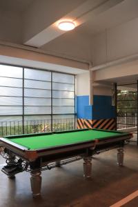 a pool table in a room with large windows at Meteor gardens in Nairobi
