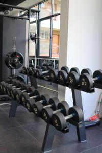 a row of dumbbell racks in a gym at Meteor gardens in Nairobi