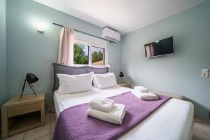 a bedroom with a bed with towels on it at Petronila Luxury Villa with heated private pool in Kissamos +43 photos