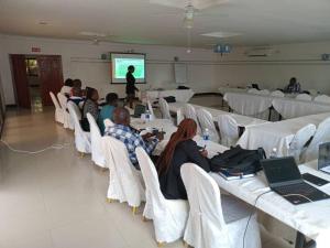 a group of people sitting in a room with laptops at Mana Nest Lodge in Choma