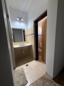 a bathroom with a tub and a sink and a toilet at Richard House in Villa Dolores +6 photos