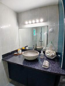 a bathroom with a counter with a sink and a mirror at BLUE DREAM SPA in Les Trois-Îlets +27 photos
