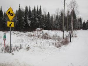 a street sign in the snow on a road at domaine de la vallee in Sainte-Rose-du-Nord