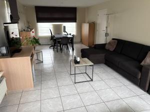 a living room with a couch and a table at Owla-Stay in Heusden - Zolder