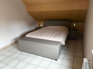a small bedroom with a bed with a white mattress at Owla-Stay in Heusden - Zolder