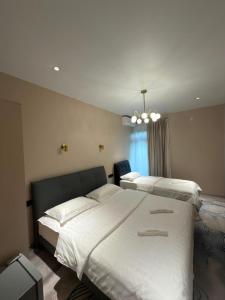 a bedroom with two beds and a chandelier at Our House in Kobuleti