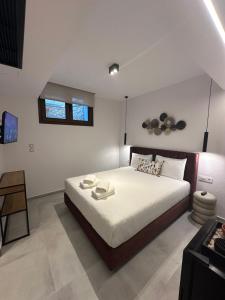 a bedroom with a large bed and a table at Perdika Ionion Villas in Perdika +107 photos