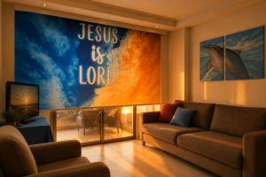 a living room with a couch and a movie poster at chalet in saint remon in Al ‘Ayn