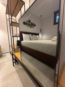 a bedroom with a bunk bed and a mirror at Perdika Ionion Villas in Perdika