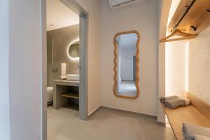 a bathroom with a mirror and a sink at IOSIF hideaway in Neos Marmaras +39 photos