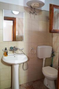 a bathroom with a sink and a toilet and a mirror at ARBERs aparthotel in Durrës +26 photos