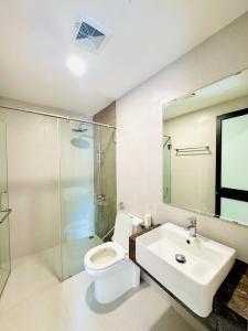 a bathroom with a toilet and a sink and a shower at Rose Home in Lao Cai +6 photos
