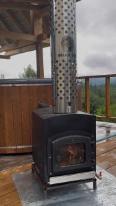 a fireplace on a deck with a view at Hillside in Slavske