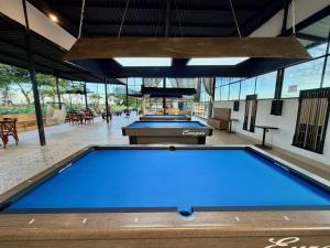 two ping pong tables in a large room with windows at Estadero Bello Horizonte in Florencia