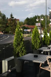 a table and chairs on a balcony with a street at Casa Braneana in Bran