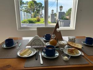 a table with a breakfast of eggs and bread and coffee at Hotel Del Parque in Corrientes