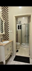 a bathroom with a shower and a sink and a toilet at hostel in Obhur in Jeddah