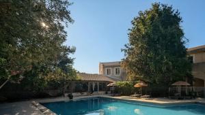 a swimming pool in front of a building at Hostellerie Saint Benoît in Aniane