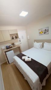 a bedroom with a large bed with two towels on it at Hotel Vistta Iracema in Fortaleza