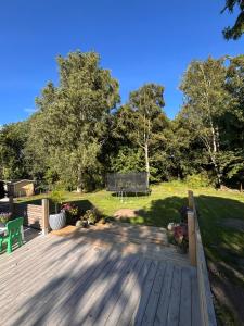 a wooden deck with a bench and a park at Kanalhuset in Tvååker