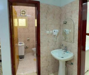 a bathroom with a sink and a toilet at Al Samia economy apartment in Baljurashi +11 photos