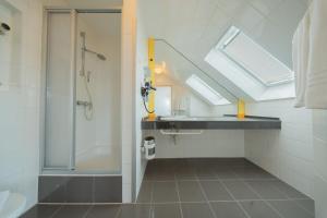 a bathroom with a shower and a sink at Juno Hotel Bremen City in Bremen +20 photos