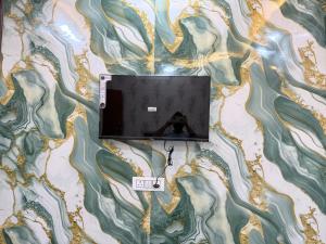 a laptop on a table with a scale on it at Hotel Drip inn JNK in Lucknow