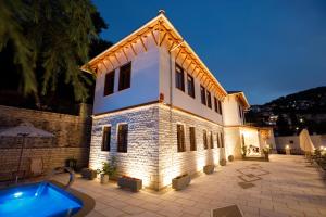 a house with a swimming pool in front of it at Vila Mantho in Gjirokastër
