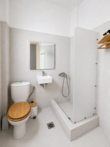 a bathroom with a toilet and a sink at The Sunset by KHI in Kithnos +34 photos