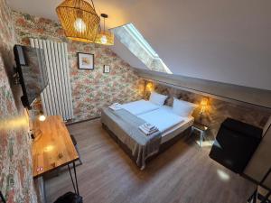a small bedroom with a bed and a staircase at Aparthotel Fairschlafen Minden in Minden
