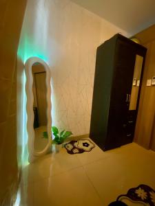 a bathroom with a mirror and a plant on the floor at Casa Hiraya - Shore 2 Tower 2 in Manila +2 photos