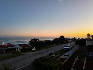 a car parked on a road with the sunset in the background at ACRE on Albatros in Gqeberha