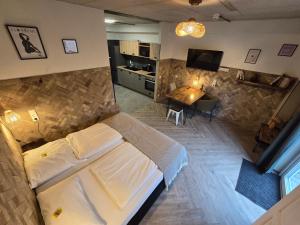 a bedroom with a large bed and a living room at Aparthotel Fairschlafen Minden in Minden