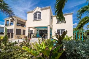 a house on the beach with palm trees at Hidden Gem The Moroccan - by ZenBreak in Christ Church