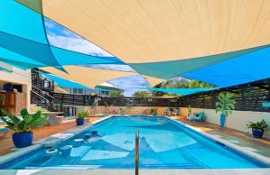an indoor swimming pool with a large wooden ceiling at Hidden Gem The Moroccan - by ZenBreak in Christ Church