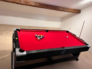 a red pool table with a pile of balls on it at Towler's Chemist in Kirkbymoorside +52 photos
