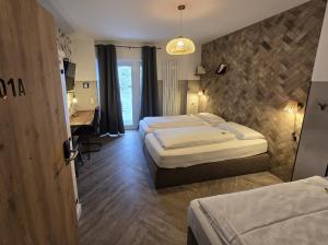 a hotel room with two beds and a desk at Aparthotel Fairschlafen Minden in Minden +78 photos