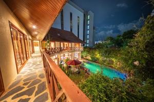an outdoor balcony of a building with a swimming pool at Orchid House Pattaya, Totally Private Pool in Pattaya South