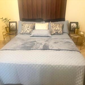 a large white bed with pillows on top of it at Cazuria - by ZenBreak in Saint George