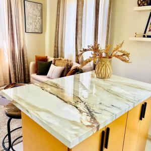 a marble counter top in a living room with a couch at Cazuria - by ZenBreak in Saint George +3 photos