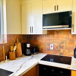a kitchen with a microwave and a counter top at Cazuria - by ZenBreak in Saint George