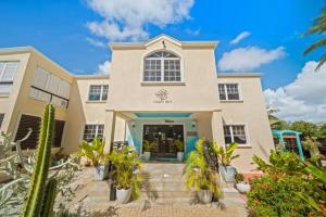 a house with palm trees in front of it at Hidden Gem The Tropical - by ZenBreak in Christ Church +16 photos