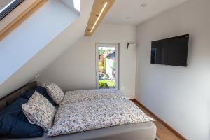 a bedroom with a bed and a flat screen tv at LU-KA Apartamenty in Swornegacie +98 photos