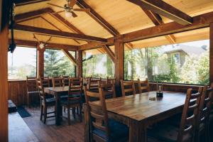 a large dining room with wooden tables and chairs at Апартаменти Helleborus in Staryy Mizunʼ