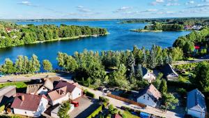 an aerial view of a village on a lake at LU-KA Apartamenty in Swornegacie