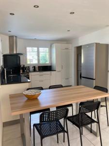 a kitchen with a large wooden table and chairs at Villa dolce vita in Murten