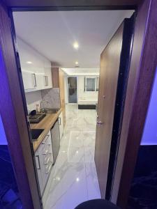 a kitchen with a door open to a kitchen with a sink at Premium Studio Family in Paralia Katerinis