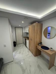 a bathroom with a sink and a mirror on the wall at Premium Studio Family in Paralia Katerinis +4 photos