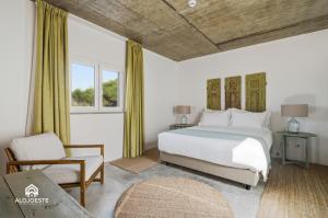 a bedroom with a bed and a chair and a window at OceanLand - Santa Cruz in Santa Cruz +75 photos